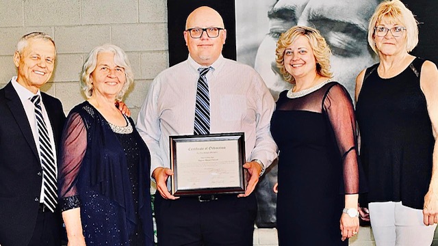 Pastor holding certificate