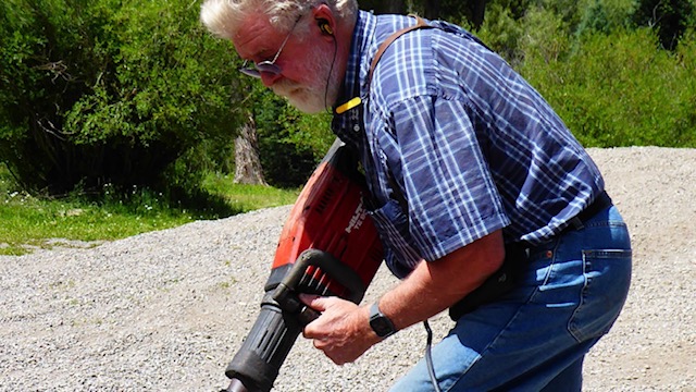 Man using power stake driver