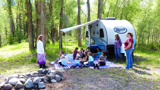 Group of people outside a camper trailer